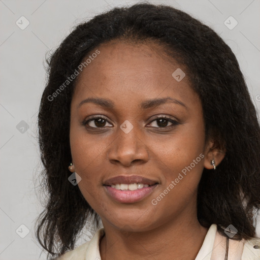 Joyful black young-adult female with long  brown hair and brown eyes