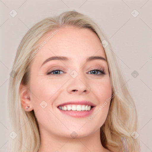 Joyful white young-adult female with long  brown hair and blue eyes