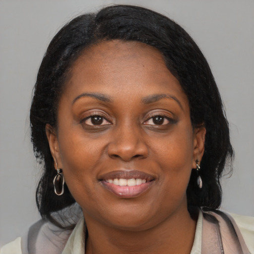 Joyful black young-adult female with medium  brown hair and brown eyes