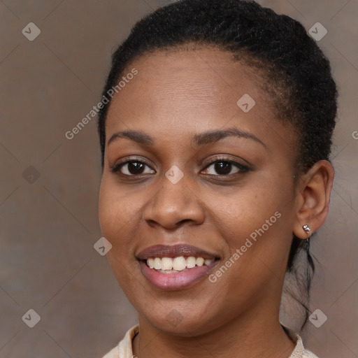 Joyful black young-adult female with long  brown hair and brown eyes