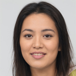 Joyful asian young-adult female with long  brown hair and brown eyes