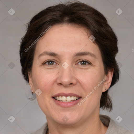 Joyful white adult female with medium  brown hair and grey eyes