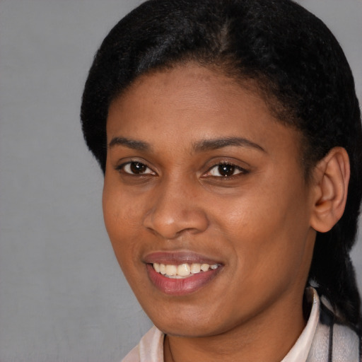 Joyful black young-adult female with short  brown hair and brown eyes