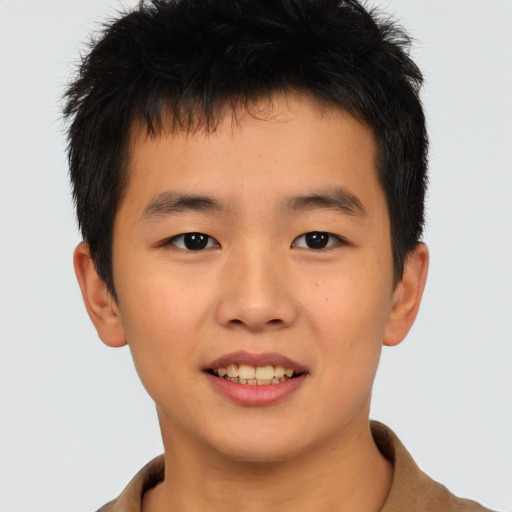 Joyful asian child male with short  brown hair and brown eyes
