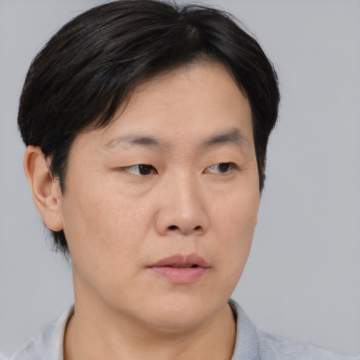 Neutral asian young-adult male with short  brown hair and brown eyes