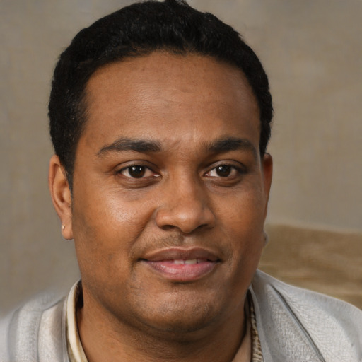 Joyful black young-adult male with short  brown hair and brown eyes