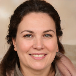 Joyful white adult female with medium  brown hair and brown eyes