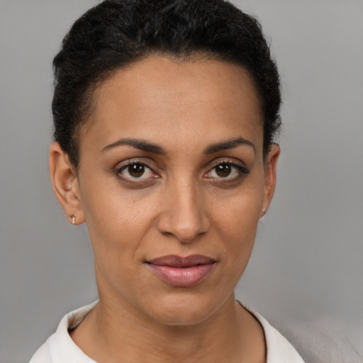 Joyful latino young-adult female with short  brown hair and brown eyes