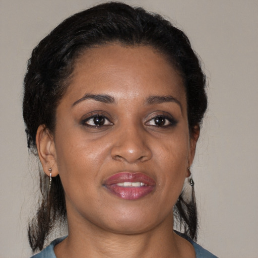 Joyful black young-adult female with medium  brown hair and brown eyes