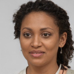 Joyful black adult female with short  brown hair and brown eyes