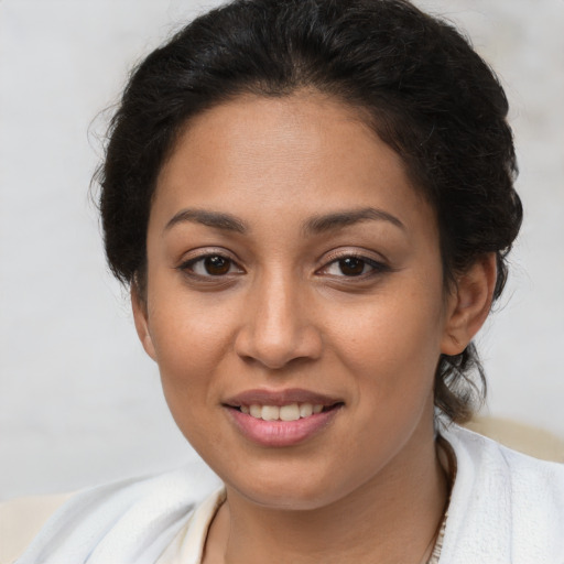 Joyful latino young-adult female with short  brown hair and brown eyes