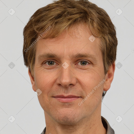 Joyful white adult male with short  brown hair and grey eyes