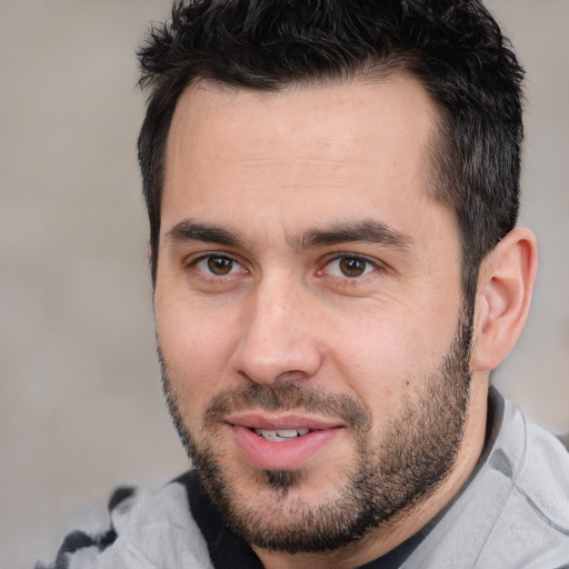 Joyful white young-adult male with short  black hair and brown eyes