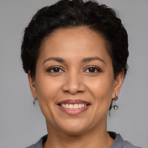 Joyful white adult female with short  brown hair and brown eyes