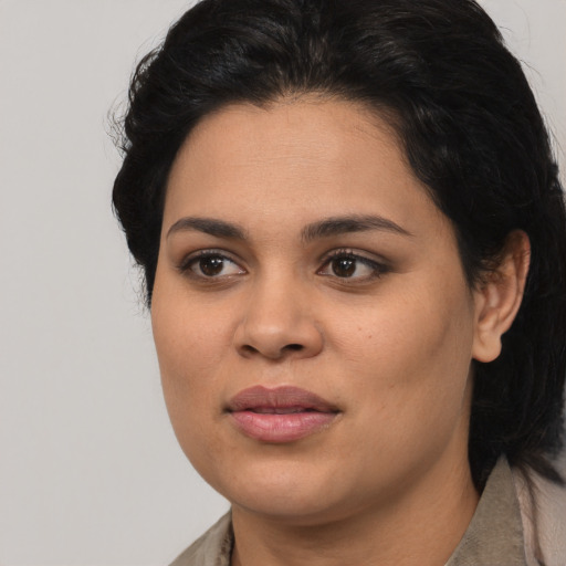 Joyful latino young-adult female with medium  black hair and brown eyes