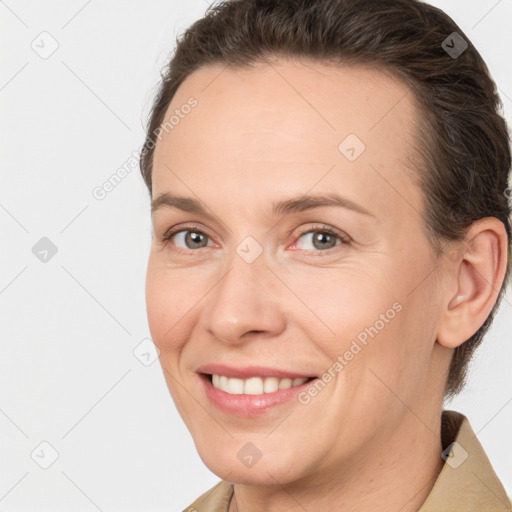 Joyful white adult female with short  brown hair and brown eyes