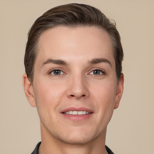 Joyful white young-adult male with short  brown hair and grey eyes