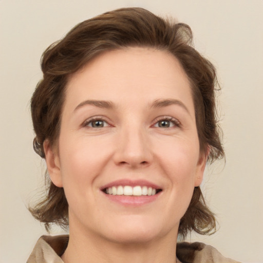 Joyful white adult female with medium  brown hair and green eyes