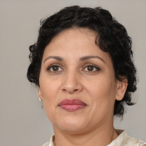 Joyful latino adult female with short  brown hair and brown eyes