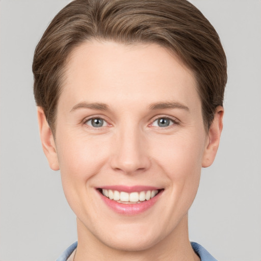 Joyful white young-adult female with short  brown hair and grey eyes