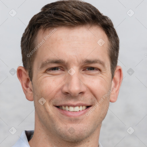 Joyful white adult male with short  brown hair and grey eyes