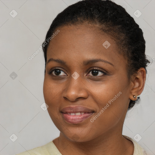 Joyful black young-adult female with short  brown hair and brown eyes