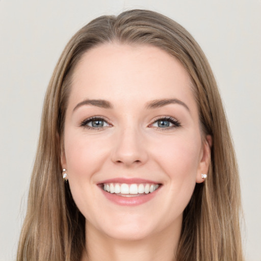 Joyful white young-adult female with long  brown hair and grey eyes