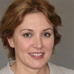 Joyful white adult female with medium  brown hair and brown eyes