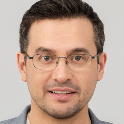 Joyful white adult male with short  brown hair and brown eyes