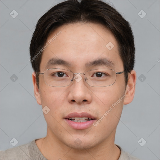 Joyful asian young-adult male with short  brown hair and brown eyes