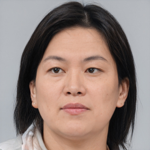 Neutral asian adult female with medium  brown hair and brown eyes