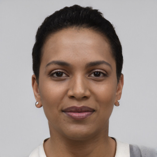 Joyful latino young-adult female with short  black hair and brown eyes