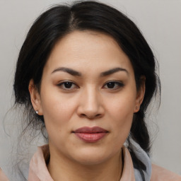 Joyful asian young-adult female with medium  brown hair and brown eyes