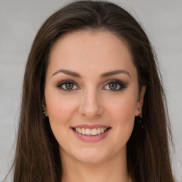 Joyful white young-adult female with long  brown hair and green eyes