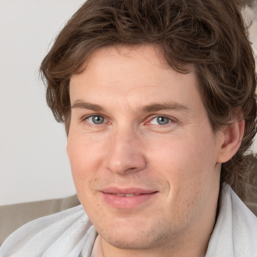 Joyful white adult male with short  brown hair and grey eyes