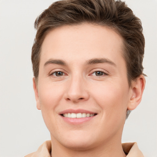 Joyful white young-adult female with short  brown hair and grey eyes