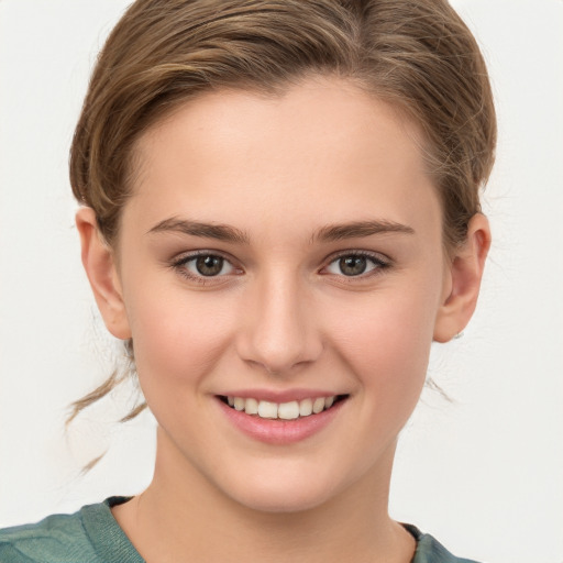 Joyful white young-adult female with medium  brown hair and grey eyes