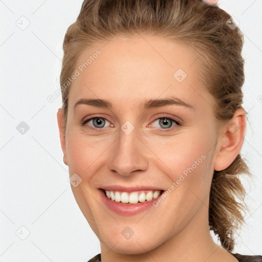 Joyful white young-adult female with short  brown hair and grey eyes