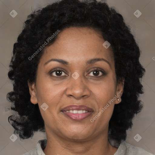 Joyful black adult female with medium  brown hair and brown eyes