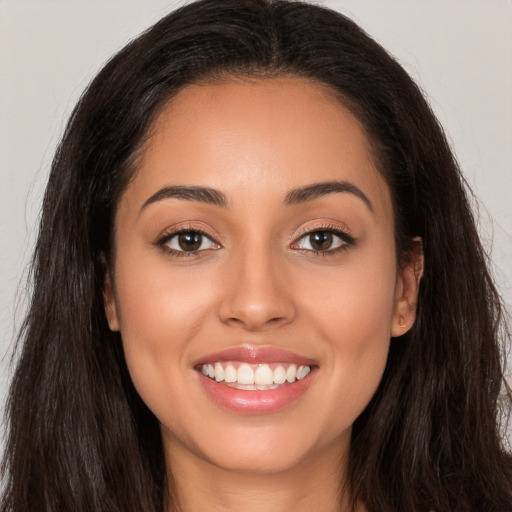 Joyful white young-adult female with long  brown hair and brown eyes