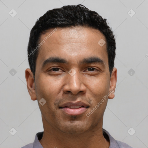 Joyful latino young-adult male with short  black hair and brown eyes