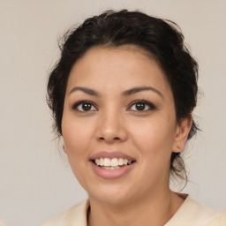 Joyful latino young-adult female with medium  brown hair and brown eyes