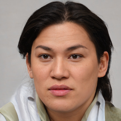 Joyful asian adult female with medium  brown hair and brown eyes