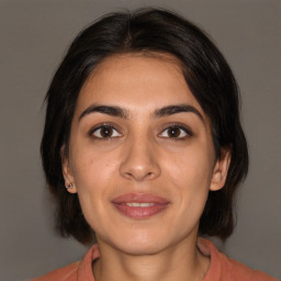 Joyful white young-adult female with medium  brown hair and brown eyes