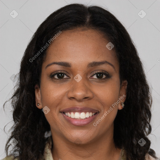 Joyful black young-adult female with long  brown hair and brown eyes