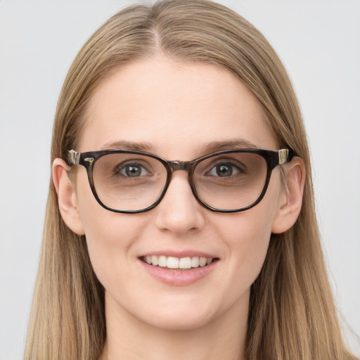 Joyful white young-adult female with long  brown hair and blue eyes