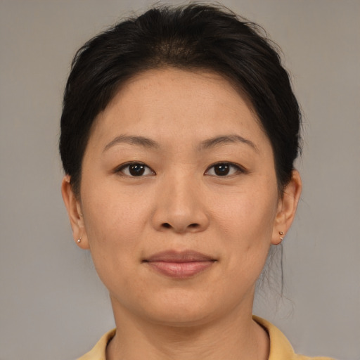 Joyful asian adult female with short  brown hair and brown eyes