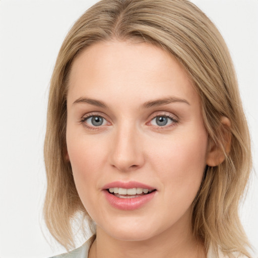 Joyful white young-adult female with medium  brown hair and blue eyes