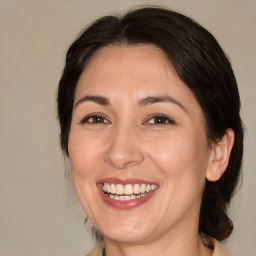 Joyful white adult female with medium  brown hair and brown eyes