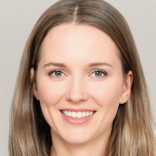 Joyful white young-adult female with long  brown hair and brown eyes